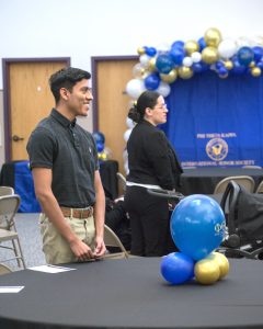 Excitement builds as names are called and students approach the podium to receive their honors