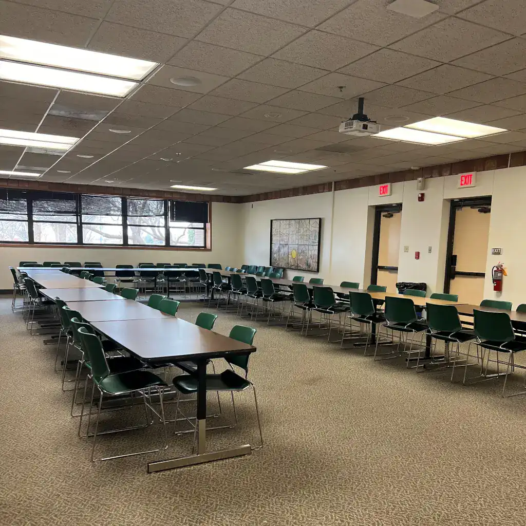 A photo of the CUB Multi-Purpose room. The tables are laid out in a horseshoe pattern.