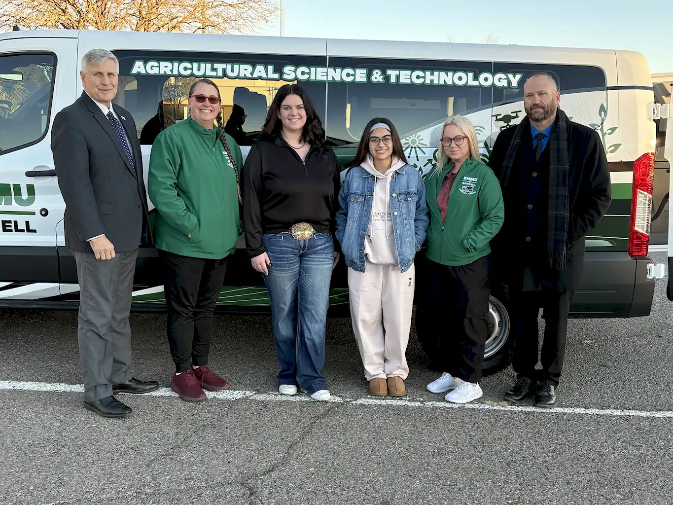 The newly formed ENMU-Roswell Livestock Judging Team stands in front of the Agricultural Science & Technology passenger van, along with the ENMU-Roswell President and the Interim VP of Academic and Student Affairs.